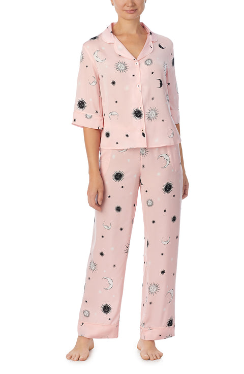 A lady wearing pink quarter sleeve gramercy pj set with over the moon print.