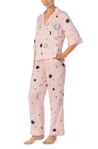 A lady wearing pink quarter sleeve gramercy pj set with over the moon print.