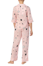 A lady wearing pink quarter sleeve gramercy pj set with over the moon print.