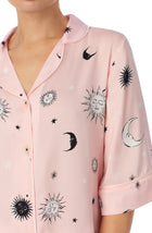 A lady wearing pink quarter sleeve gramercy pj set with over the moon print.