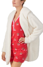 A lady wearing white Long Sleeve Aubrie Short Jacket with Vanilla print.