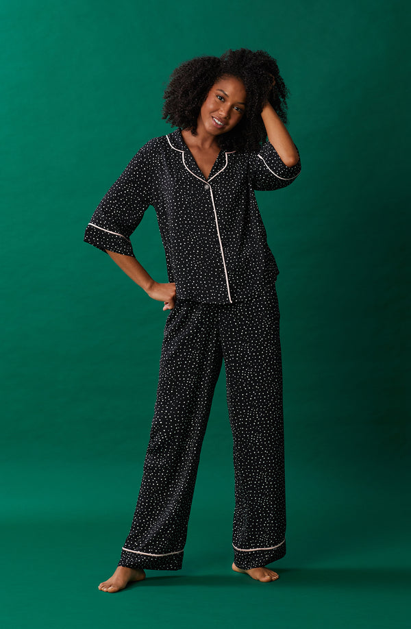 A lady wearing black quarter sleeve gramercy pj set with on the dot print.