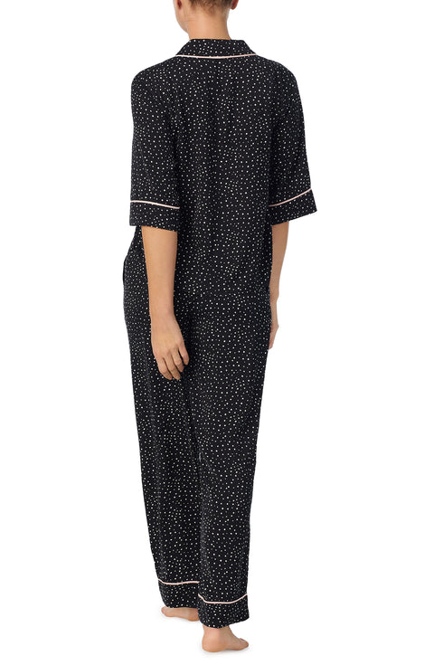 A lady wearing black quarter sleeve gramercy pj set with on the dot print.