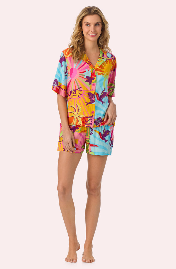 A lady wearing Georgia Short Woven Pj Set In Sunset Greeting