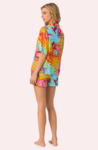 A lady wearing Georgia Short Woven Pj Set In Sunset Greeting