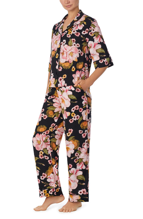 A lady wearing black quarter sleeve gramercy pj set with midnight magnolia.