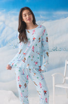 A Lady Wearing Stevie Knit Pj Set In Champagne Slopes in a front view pose against a snow background setup