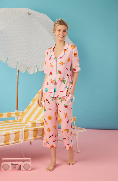A Lady Wearing Dakota Cropped Knit Pj Set In Island Party shown in a side angle walking pose