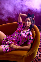 A Lady Wearing Siennna Short Knit Pj Set In Potion Commotion sitting on a sofa