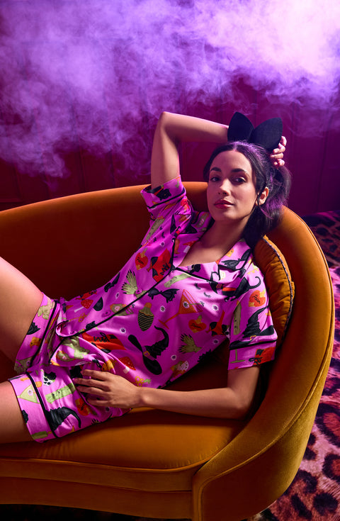 A Lady Wearing Siennna Short Knit Pj Set In Potion Commotion sitting on a sofa
