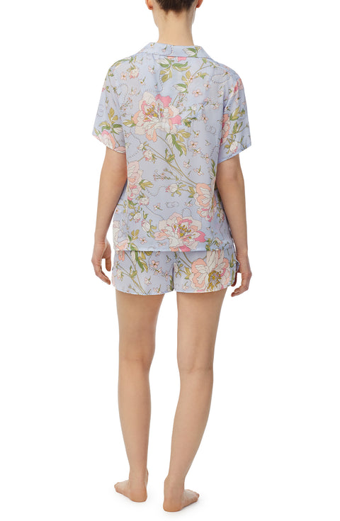 A lady wearing blue short sleeve florence pj set in blooming bride.