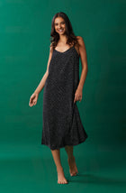 A lady wearing black sleeveless addison maxi slip with on the dot print.