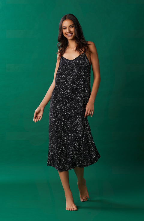 A lady wearing black sleeveless addison maxi slip with on the dot print.