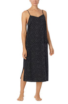 A lady wearing black sleeveless addison maxi slip with on the dot print.