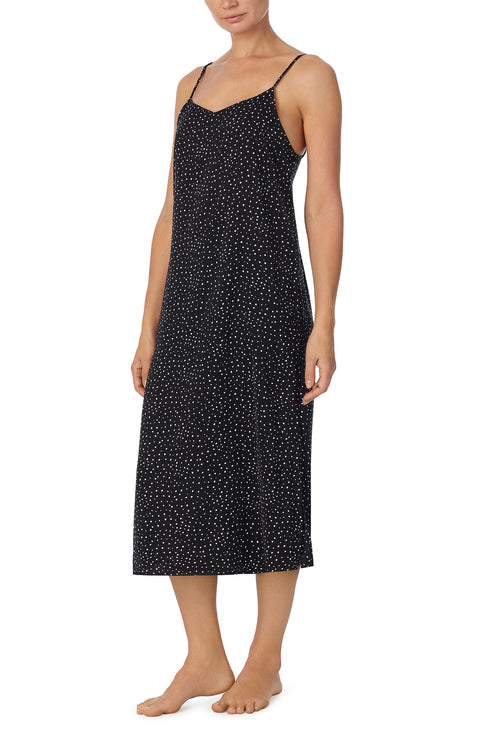 A lady wearing black sleeveless addison maxi slip with on the dot print.