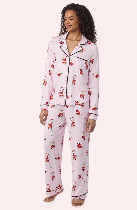 A Lady Wearing Collette Knit Pj Set In Sippin' With Santa in a front facing side angle look