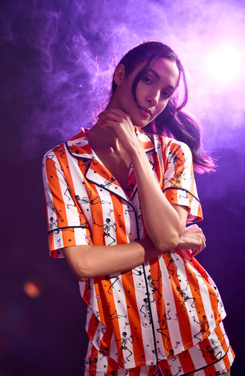 A Lady Wearing Siennna Short Knit Pj Set In Haunted Happy Hour in a purple smoky background