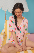 A Lady Wearing Dakota Short Knit Pj Set In Island Party shown in a front view sitting pose