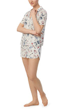A lady wearing short sleeve white florence pj set in pearl party.