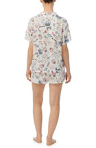 A lady wearing short sleeve white florence pj set in pearl party.