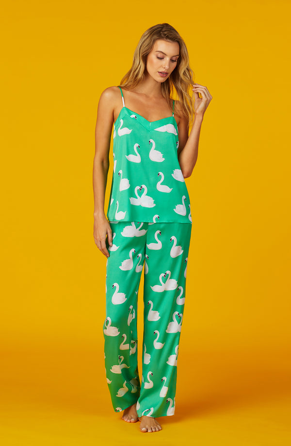 A lady wearing green sleeveless Lexi Pj Set with  Swan Soiree print.