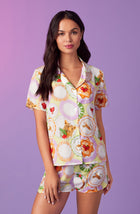 A lady wearing yellow short sleeve florence pj set in brunch please.