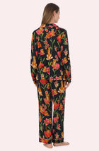 A Lady Wearing Stella Knit Pj Set In Flora & Fierce standing in a back view pose