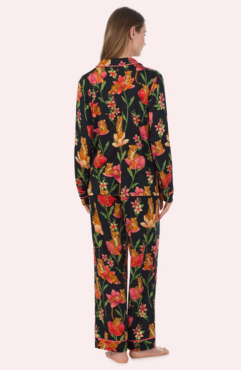 A Lady Wearing Stella Knit Pj Set In Flora & Fierce standing in a back view pose