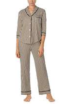 A lady wearing black and white reagent pj set with midnight stripe print.