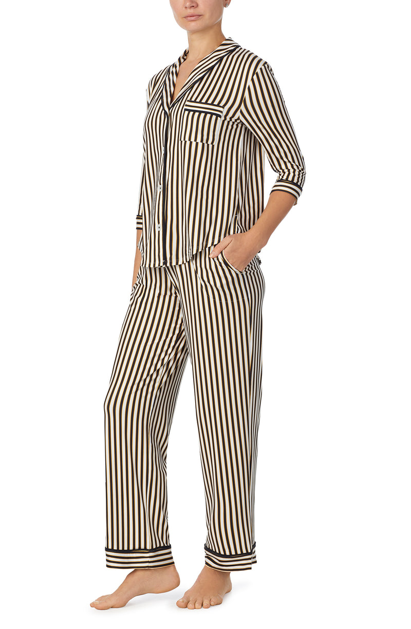 A lady wearing black and white reagent pj set with midnight stripe print.