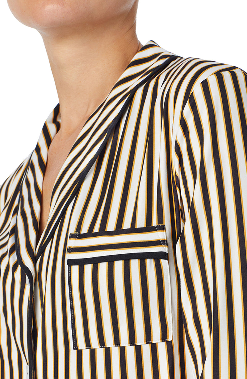 A lady wearing black and white reagent pj set with midnight stripe print.