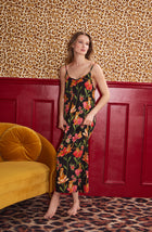 A Lady Wearing Avery Knit Chemise In Flora & Fierce standing in a front view pose against a leopard printed wall