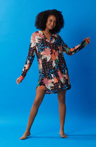 A lady wearing black long sleeve sutton sleepshirt with jungle blooms.