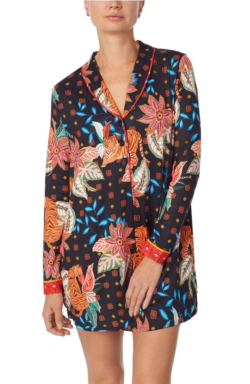 A lady wearing black long sleeve sutton sleepshirt with jungle blooms.
