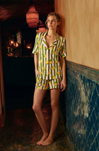 A Lady Wearing Dakota Short Knit Pj Set In Lemonade Stand Stripe shown in a side angle view with one hand in her pocket