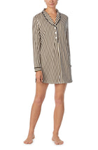 A lady wearing black and white sutton sleepshirt with midnight stripe print.