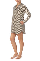 A lady wearing black and white sutton sleepshirt with midnight stripe print.
