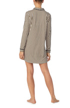 A lady wearing black and white sutton sleepshirt with midnight stripe print.
