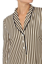 A lady wearing black and white sutton sleepshirt with midnight stripe print.