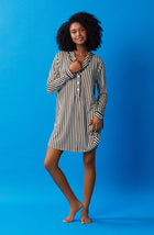 A lady wearing black and white sutton sleepshirt with midnight stripe print.