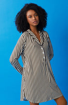 A lady wearing black and white sutton sleepshirt with midnight stripe print.