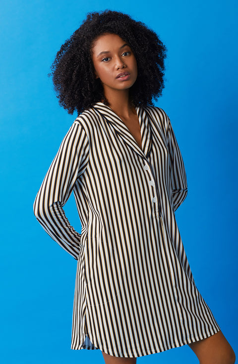 A lady wearing black and white sutton sleepshirt with midnight stripe print.