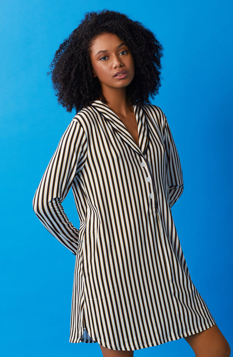 A lady wearing black and white sutton sleepshirt with midnight stripe print.