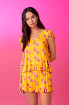 A lady wearing yellow cap sleeve phoebe pj set in sunny honey.