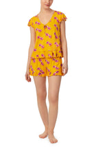 A lady wearing yellow cap sleeve phoebe pj set in sunny honey.