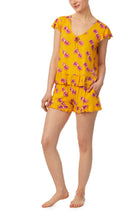 A lady wearing yellow cap sleeve phoebe pj set in sunny honey.