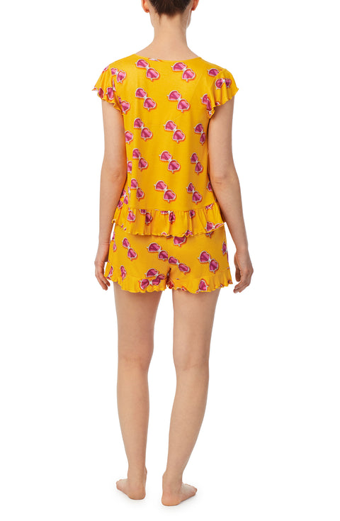 A lady wearing yellow cap sleeve phoebe pj set in sunny honey.