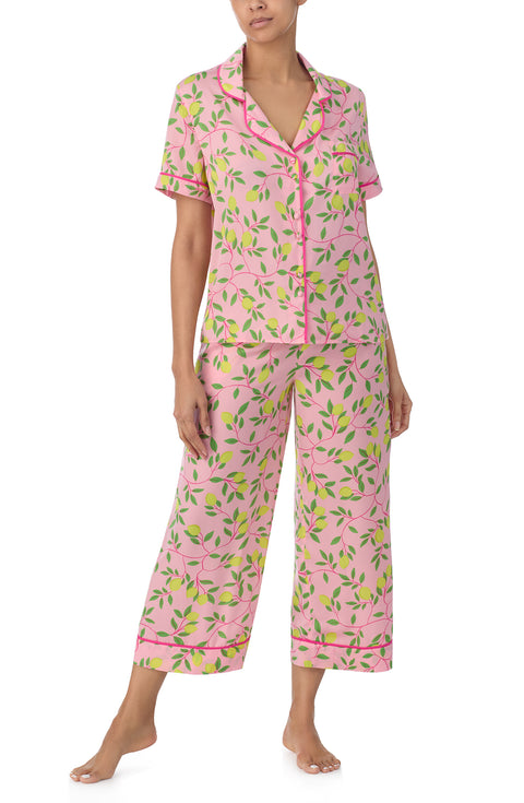 A lady wearing pink short sleeve chelsea crop pj set with pink lemonade print. 