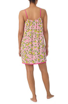 A lady wearing pink sleeveless izzy chemise with pink lemonade print.