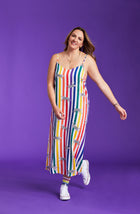 A lady wearing a pride sleeveless long maxi dress with prowling pattern.